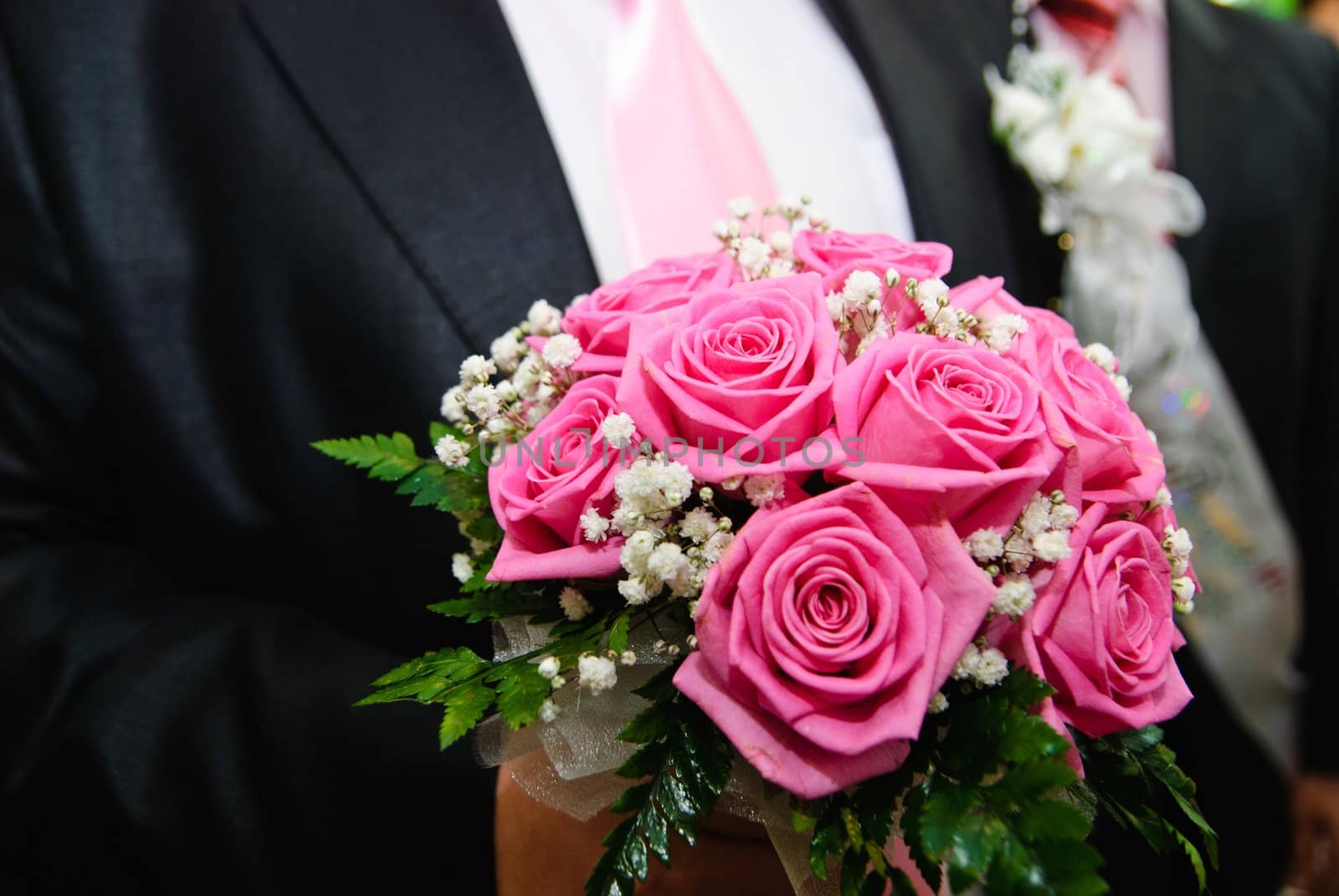 Bridal bouquet in the hand of the groom