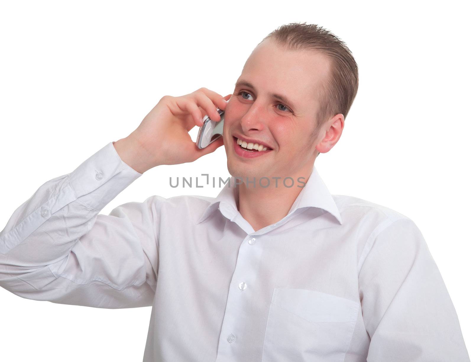 The young man says with a smile on your mobile phone. Isolated on white background