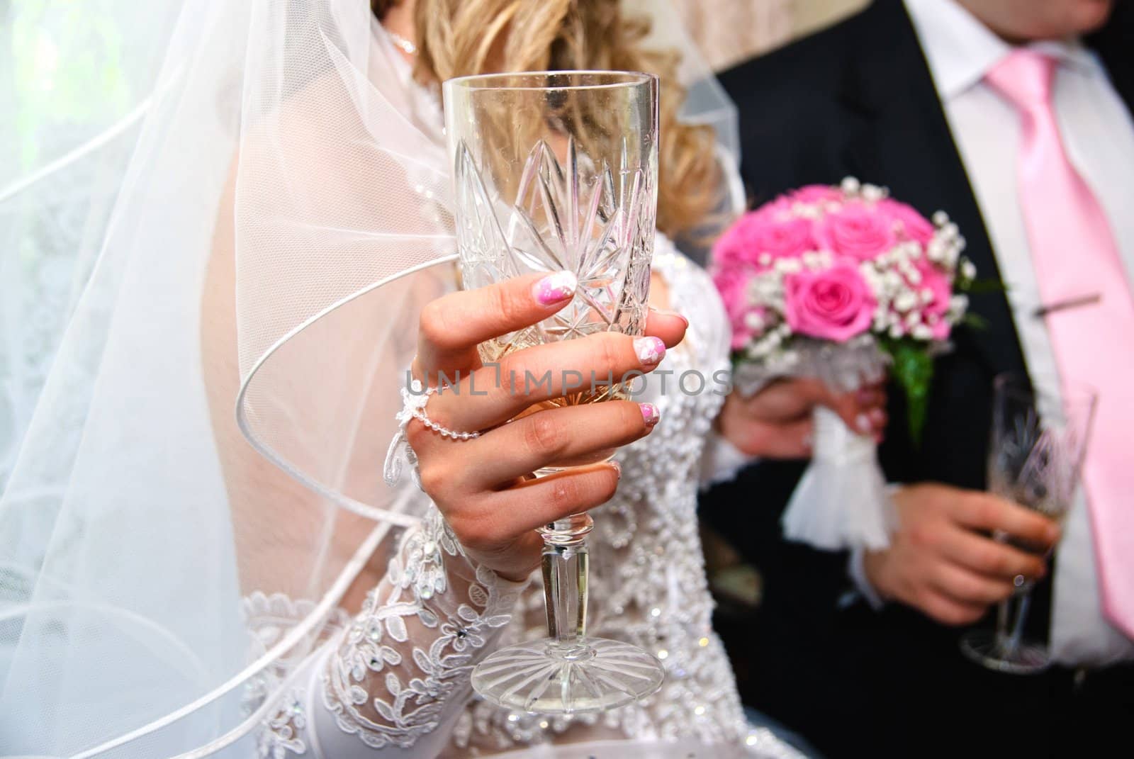 Glass of champagne in the hand of bride