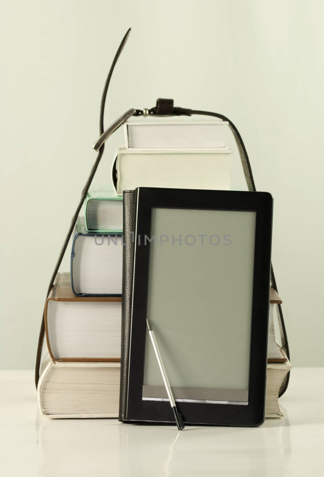 Stack of books and electronic book reader by AndreyKr