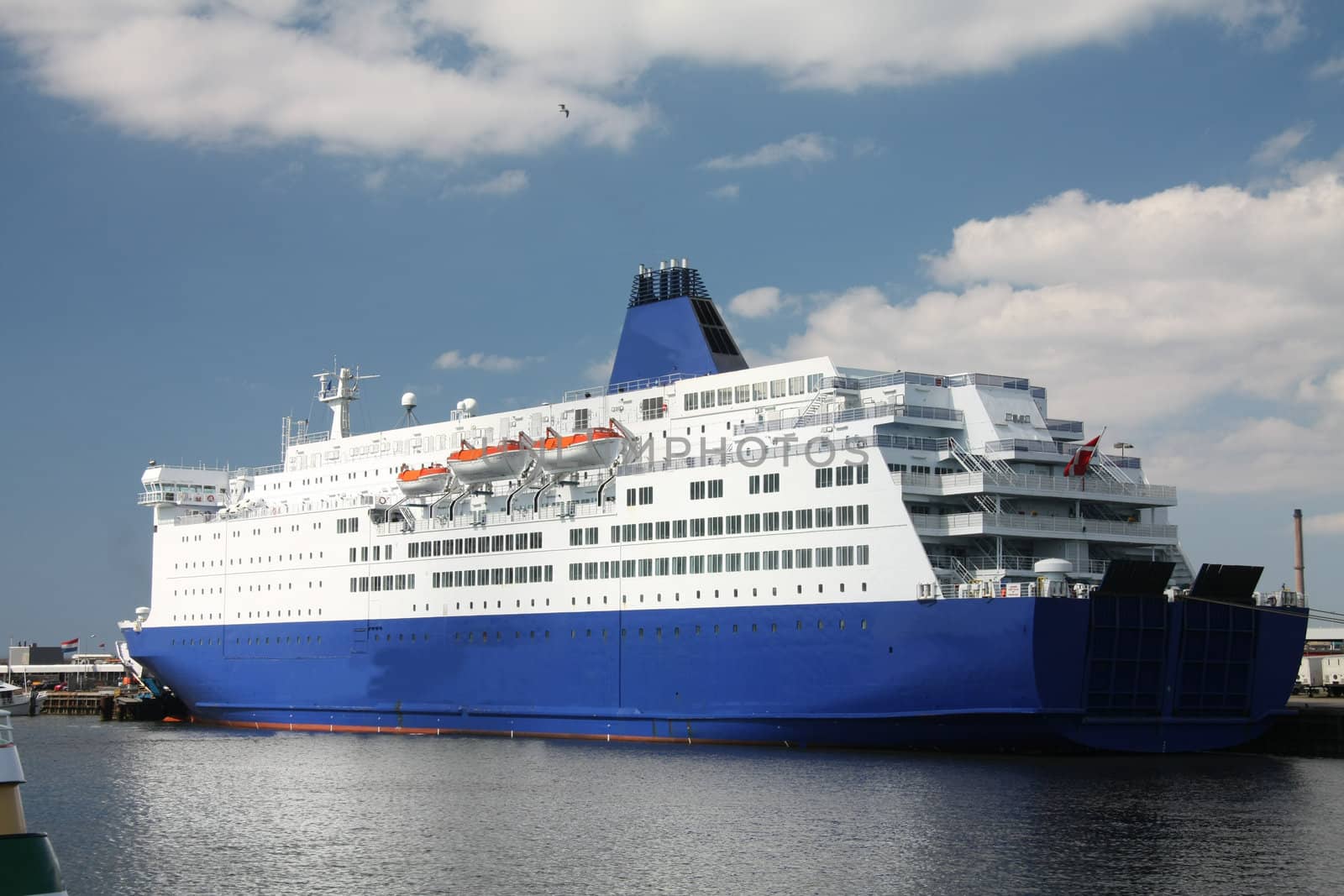 A middle sized cruise ship in the harbor