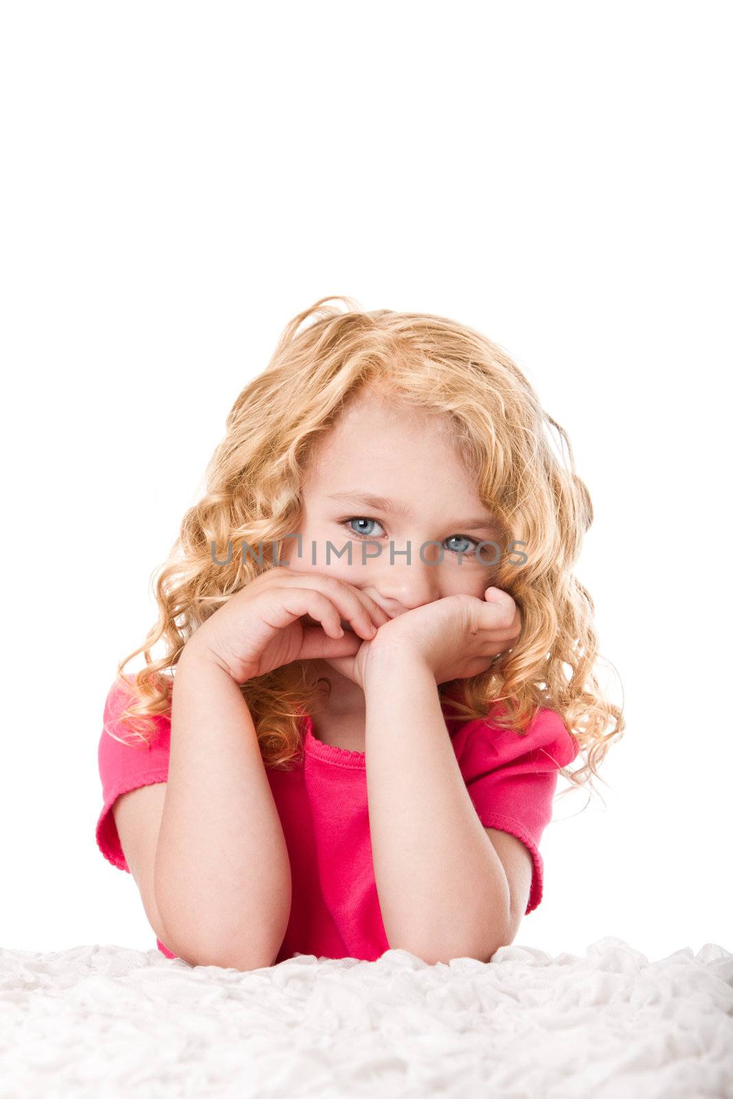 Portrait of a beautiful young girl with goldilocks curly hair and blue eyes thinking expression, isolated.