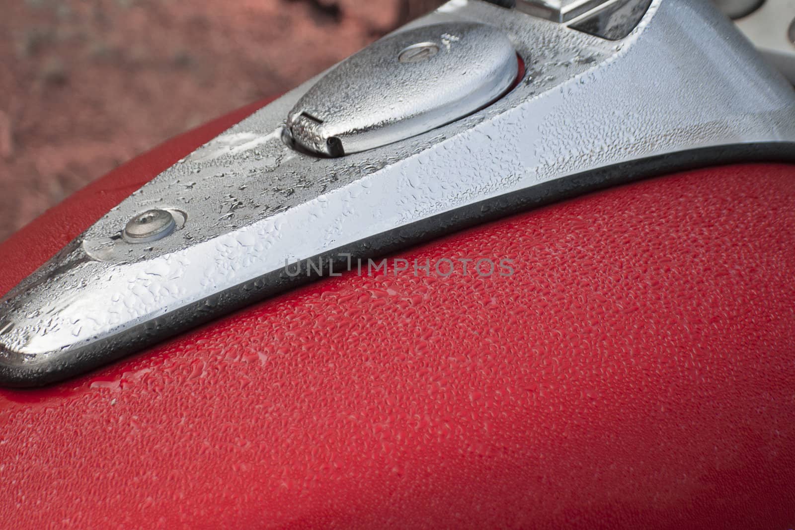 petrol tank on a motorcycle covered with morning dew, India