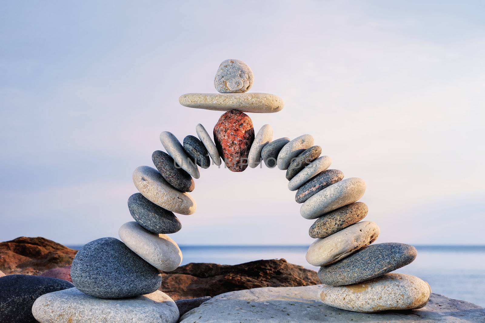 Pebbles curved as arch on the seashore