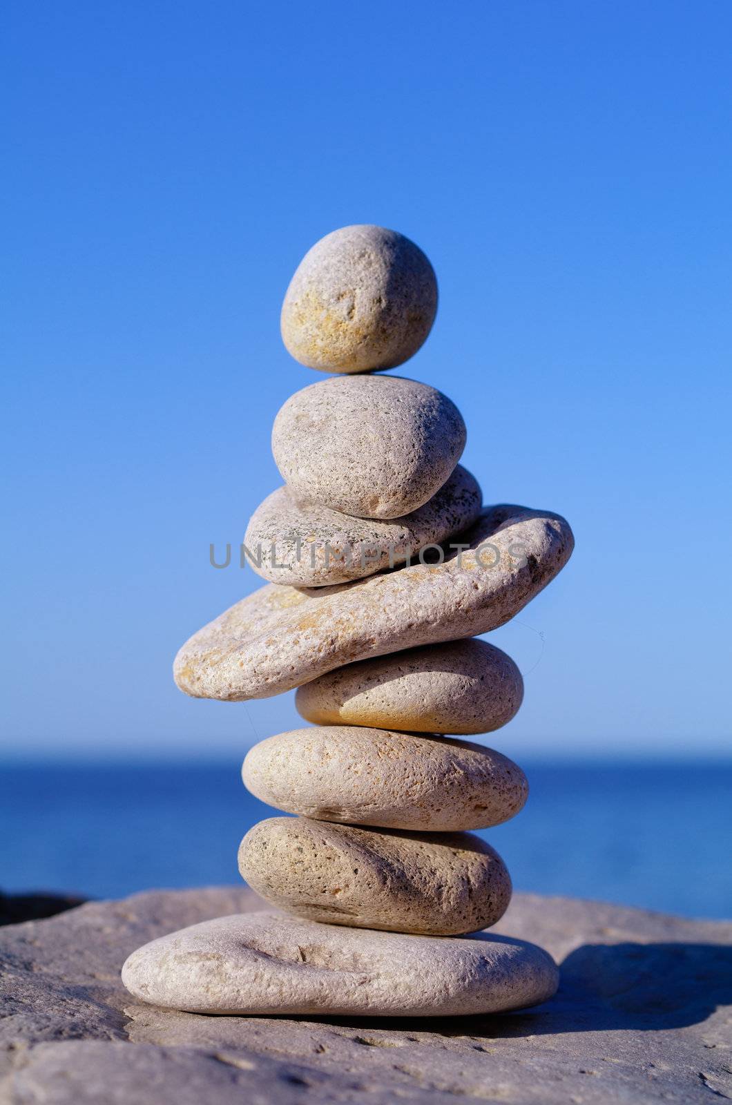 Pile of pebbles in the balance on the seacoast