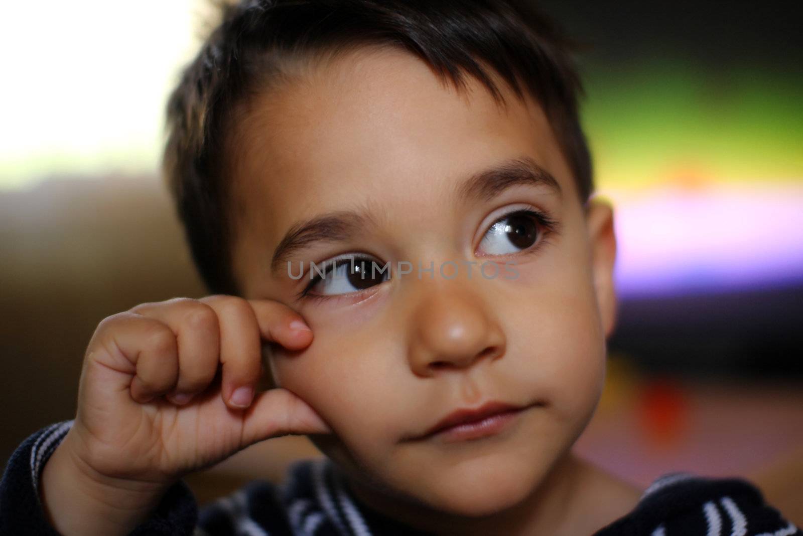 A male child thinking watching on the right