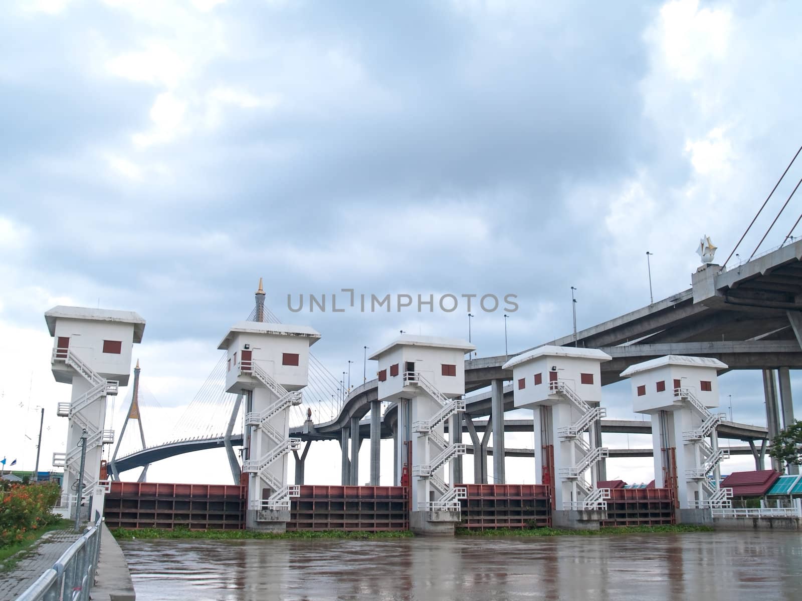 Floodgate with Bhumibol Bridge also casually call as Industrial Ring Road Bridge, Samut Prakarn,Thailand