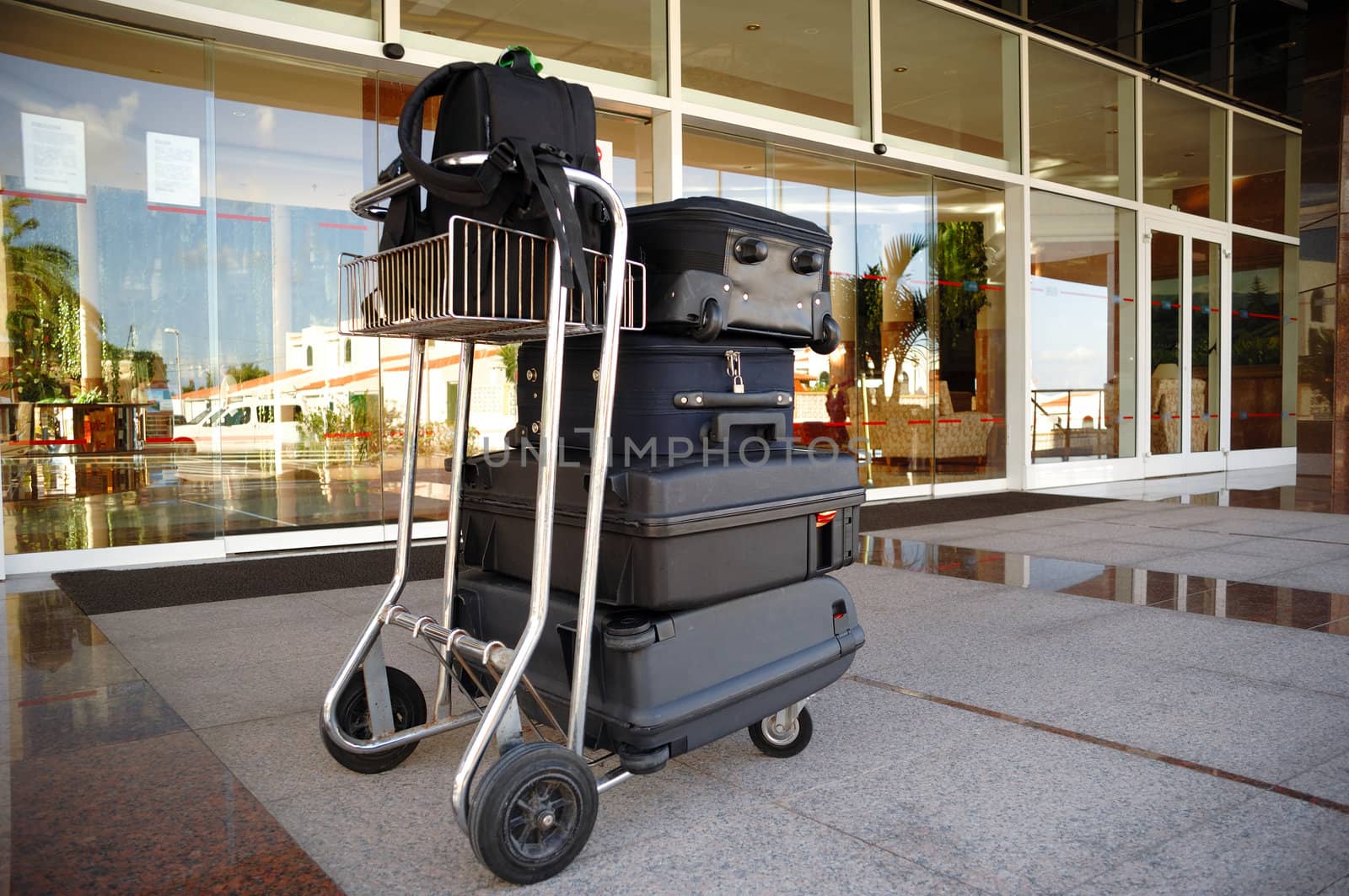 Trolley with suitcases in front of hotel