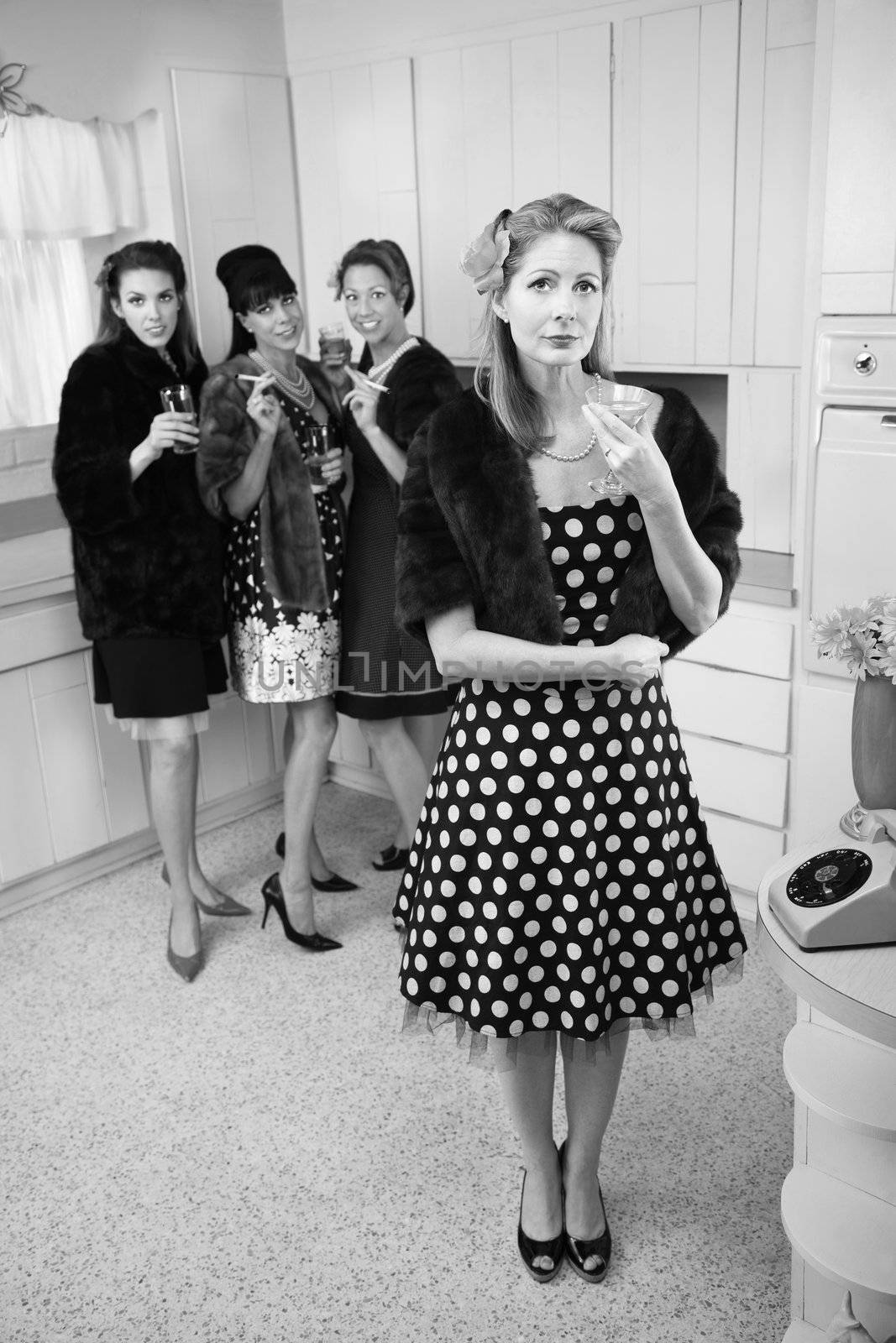 Four women smoking and drinking in a retro-style kitchen scene