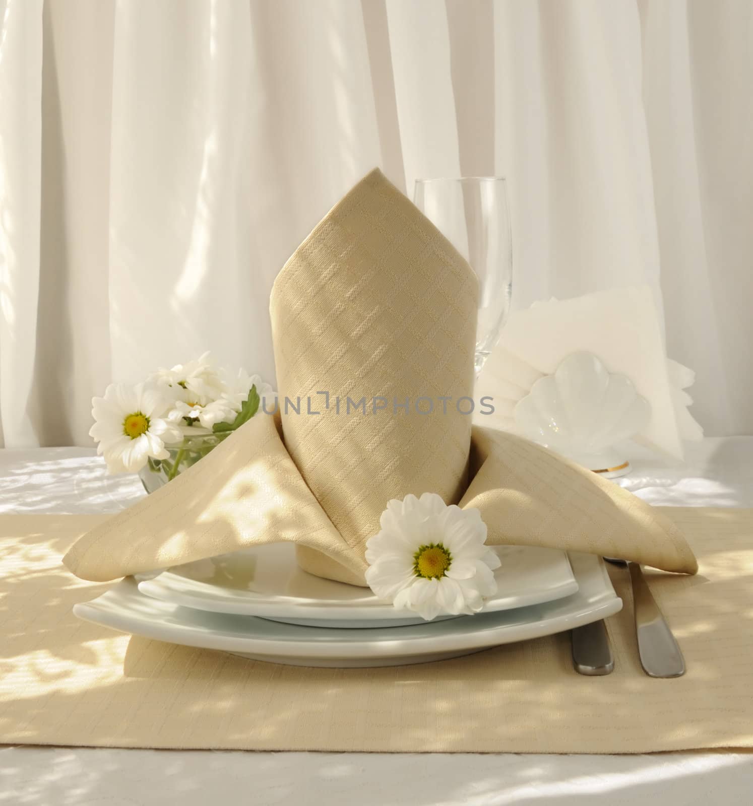 Coordinated decorative napkin on a plate with cutlery