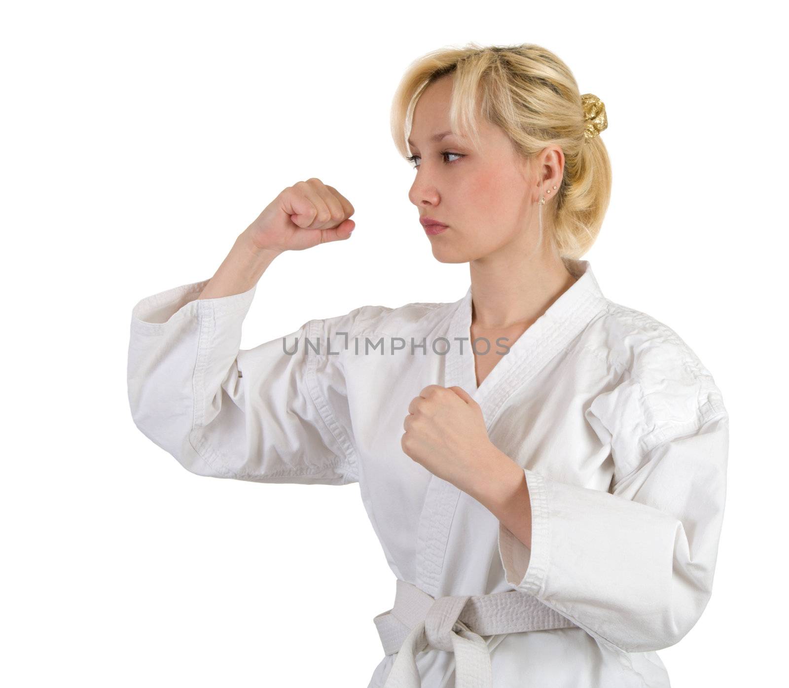 Blonde in a kimono in karate pose isolated on white background.