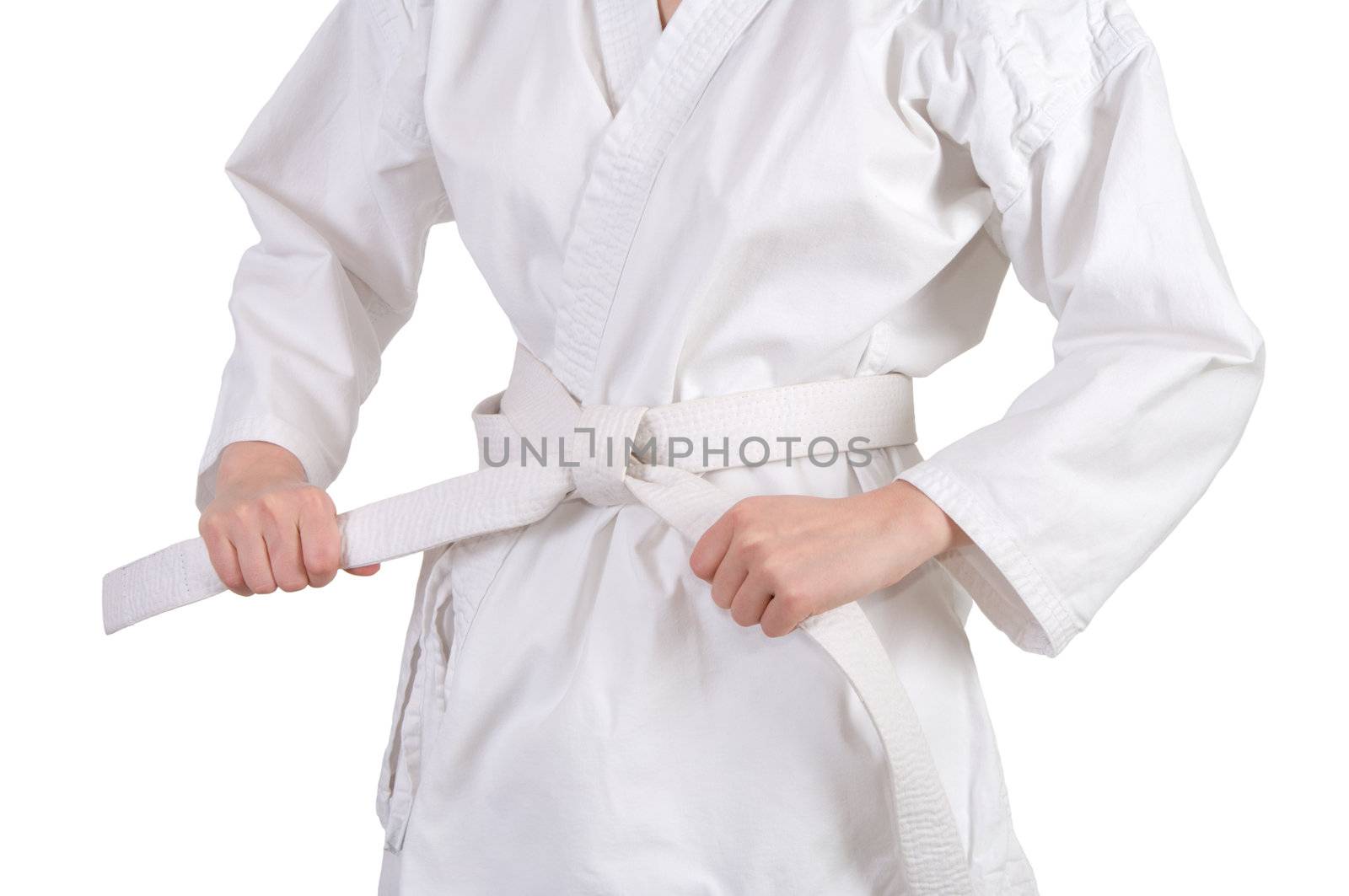 Man ties the belt on a kimono is isolated on a white background.