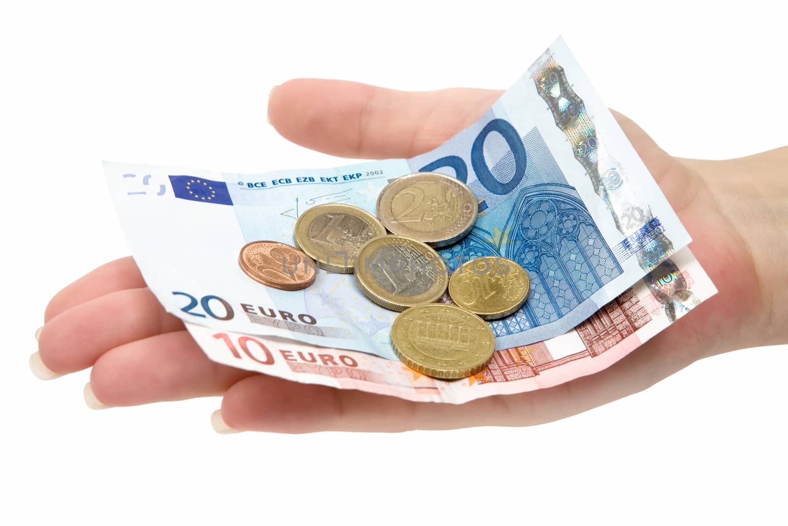 Female hand holding Euro banknotes and coins. Isolated on a white background.
