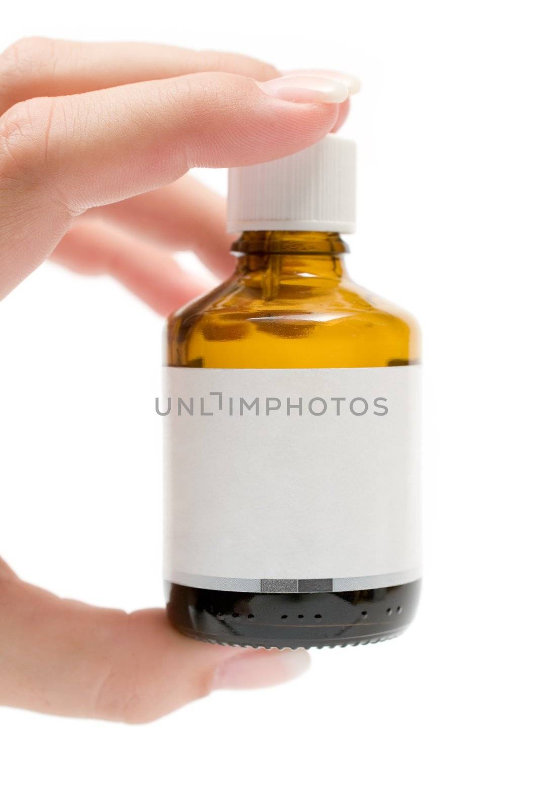 Female hand holding a small bottle. Blank Label. Isolated on a white background.