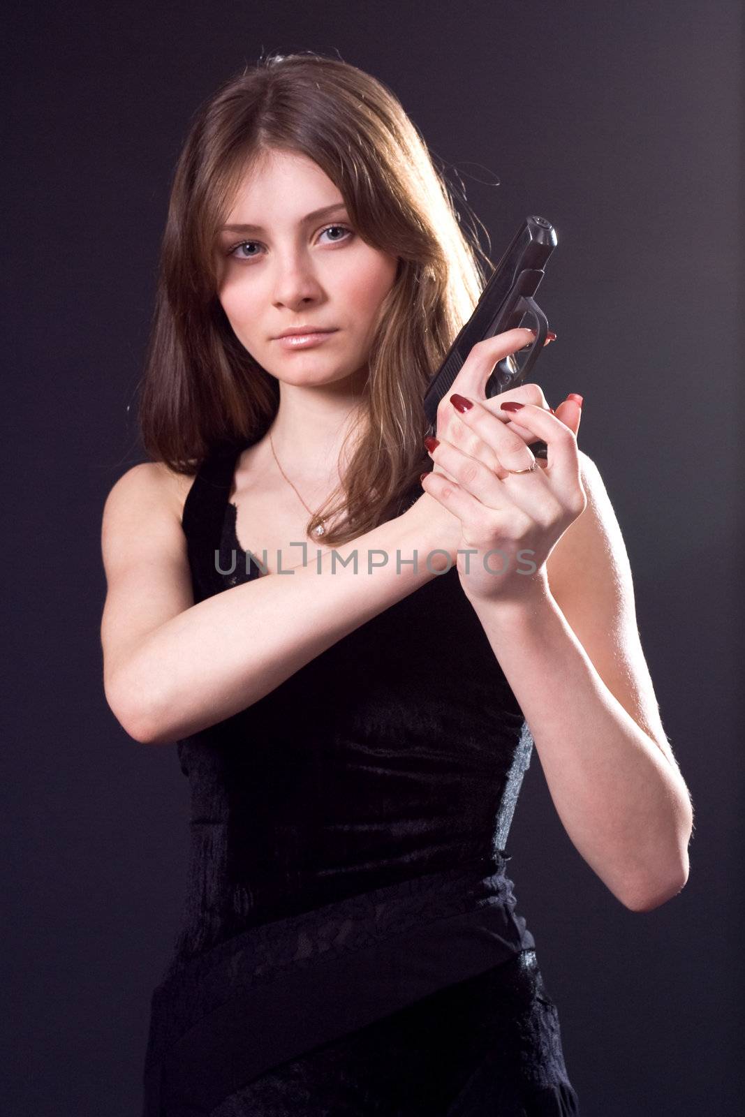 lady in black handing pistol
