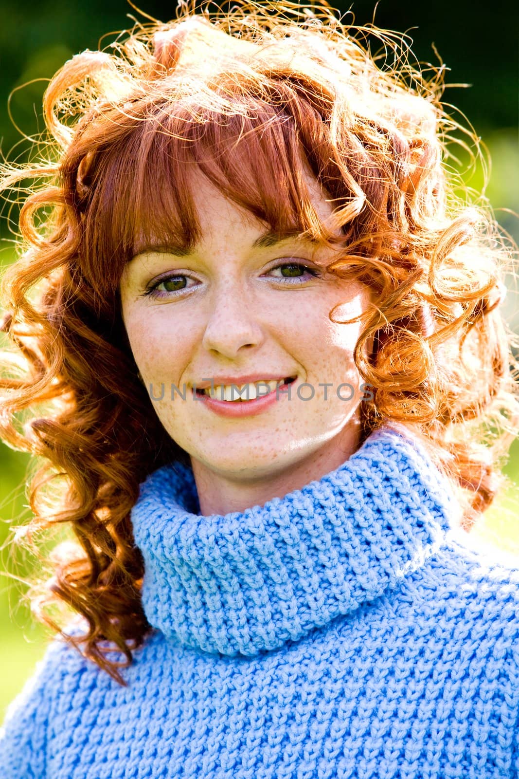 Close-up bright portrait of red-haired lovely young woman outdoors