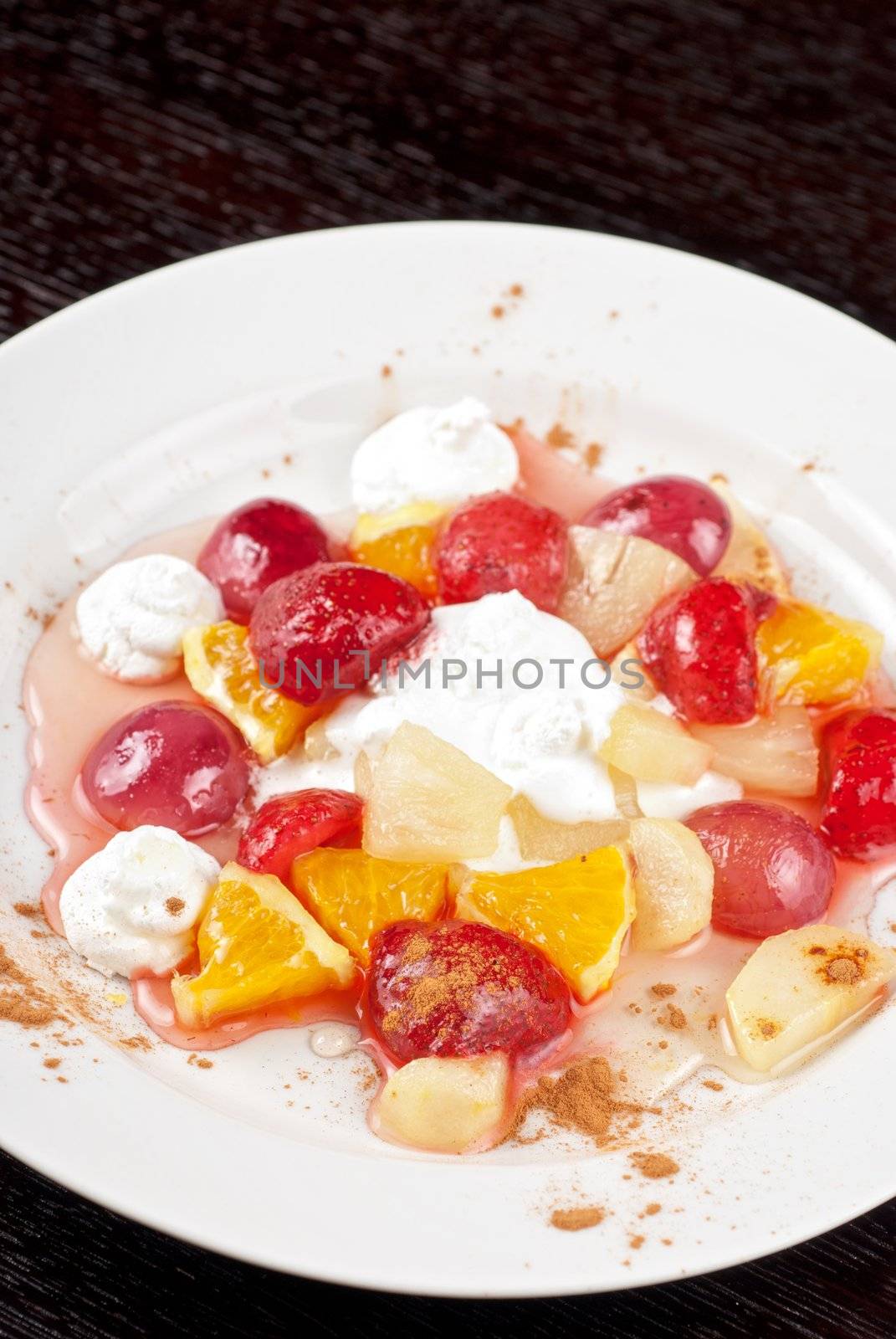 fruit salad of pineapple, grape, orange and strawberry with whipped cream