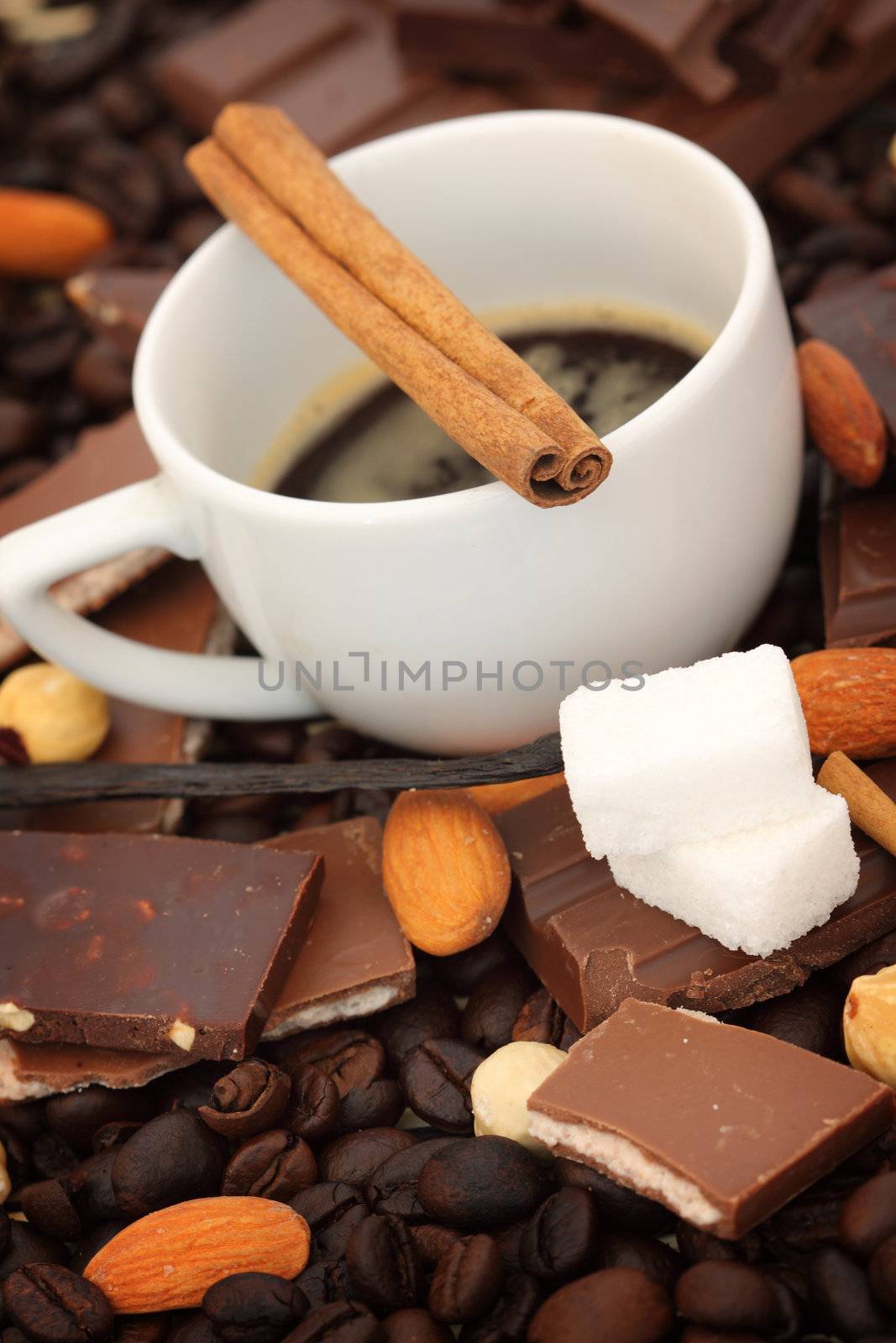 Close up of coffee cup, chocolate with hazelnuts, shallow dof 