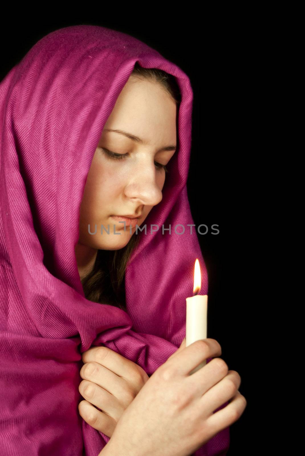 Eastern style dressed teen girl with a candle
