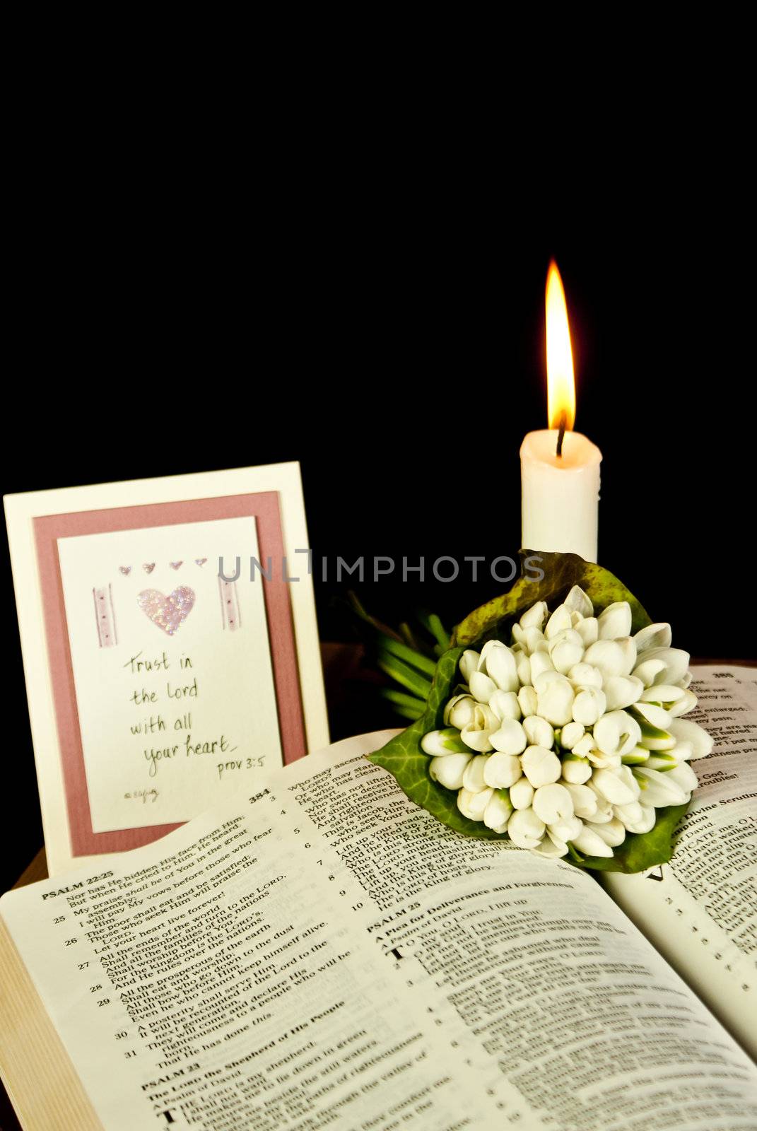 Open Bible with burning candle by AndreyKr