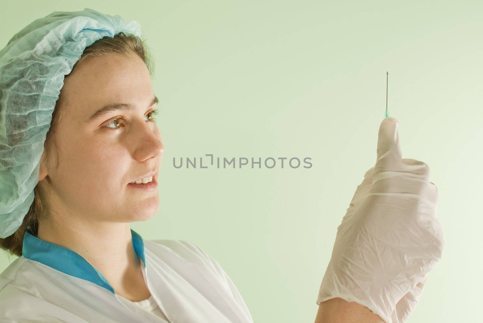 Young lady doctor with syringe