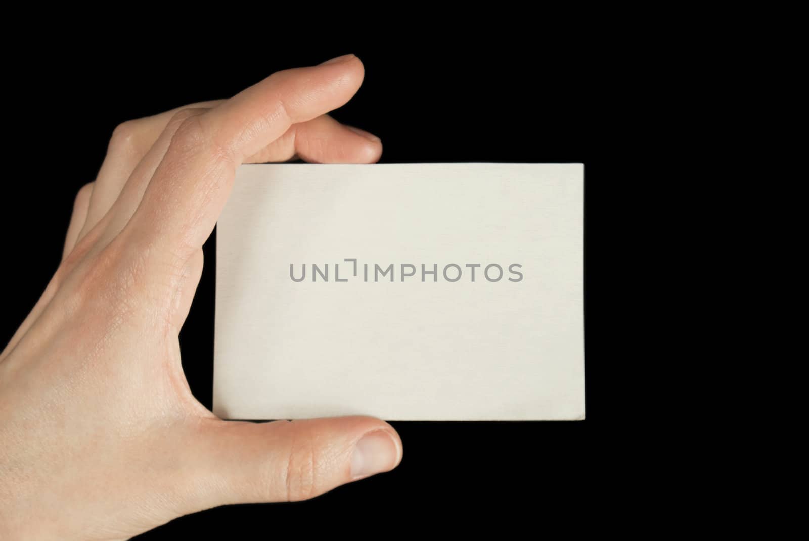Hand holding a white card isolated on black background by AndreyKr