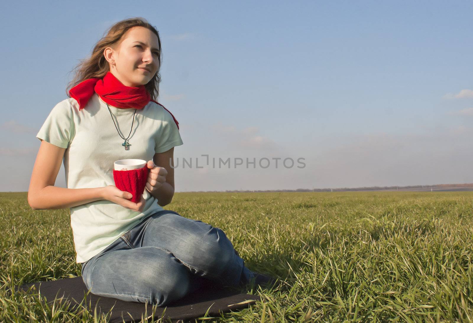 Teen girl sitting outdoors with a cup by AndreyKr