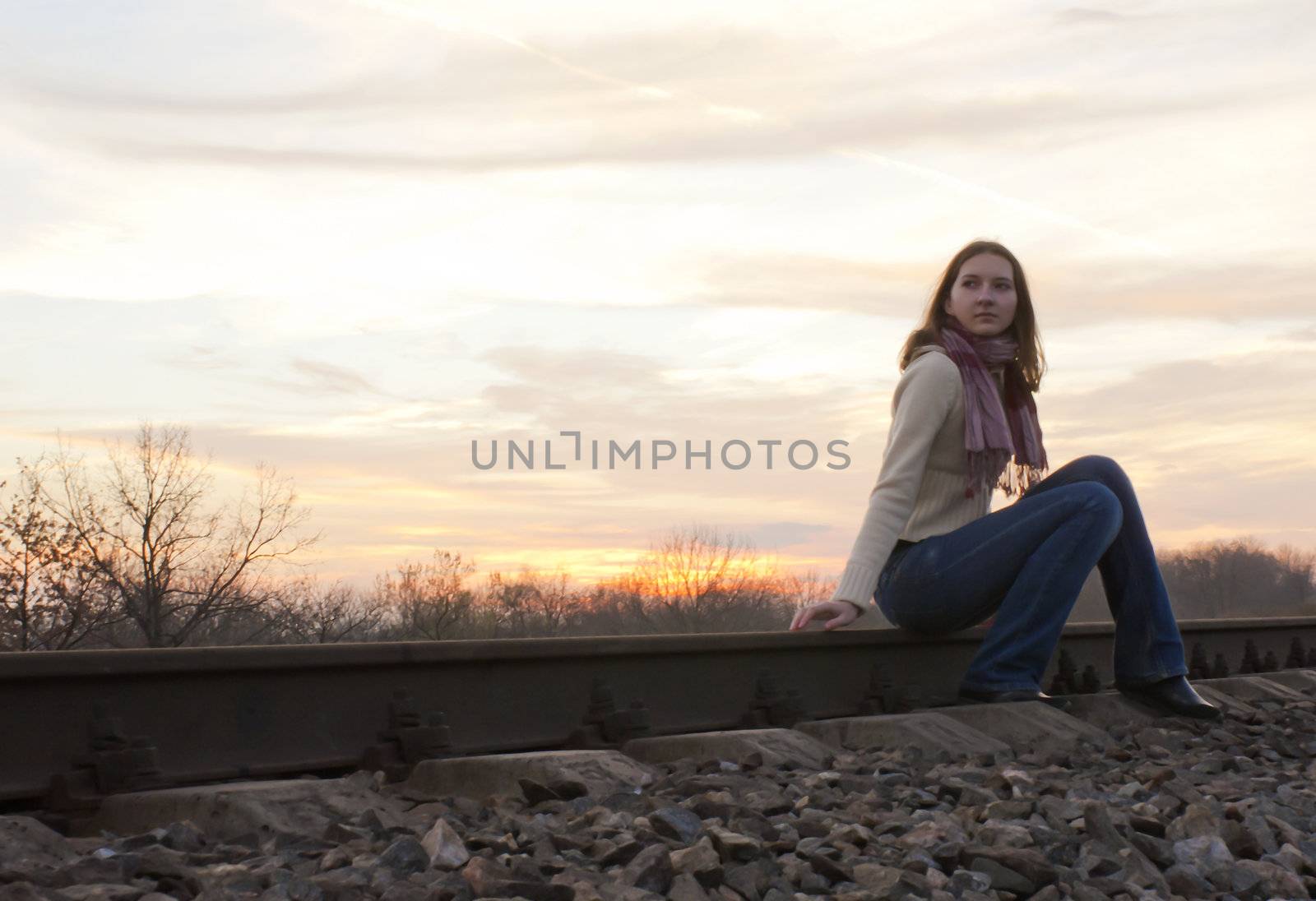 Teen girl sitting near the railways by AndreyKr