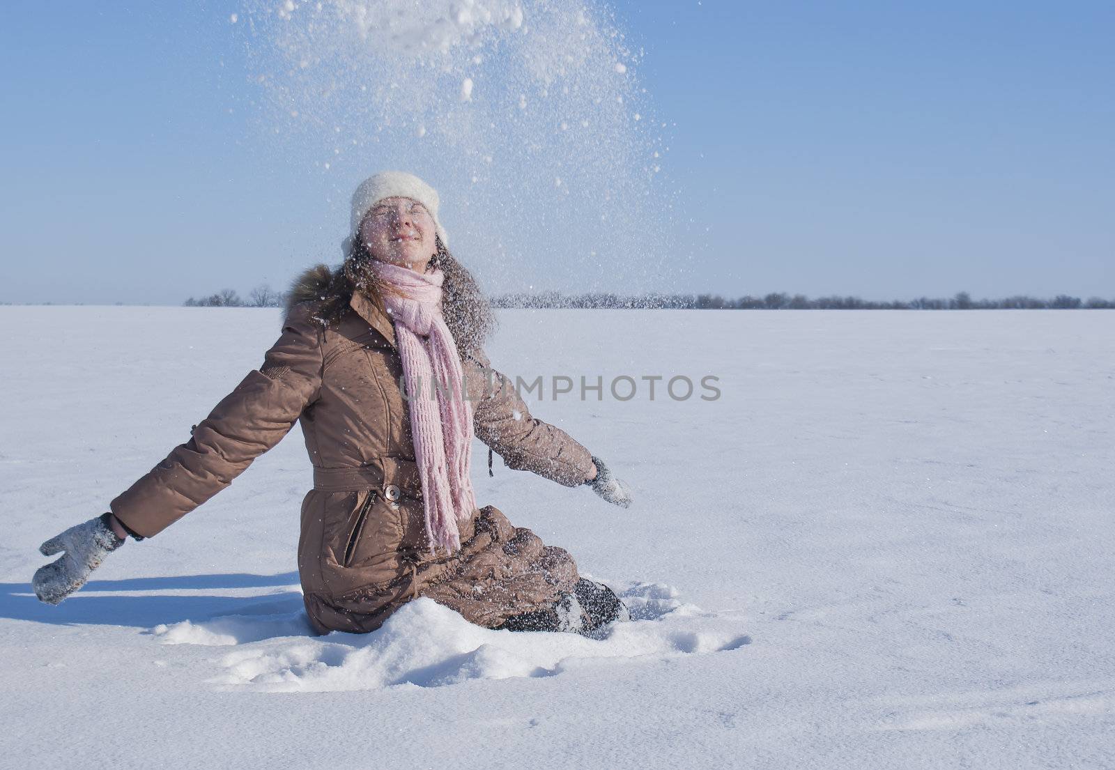 Teen girl playing with snow