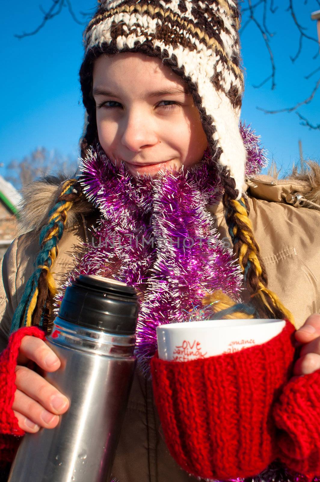 Girl holding a cup with hot drink