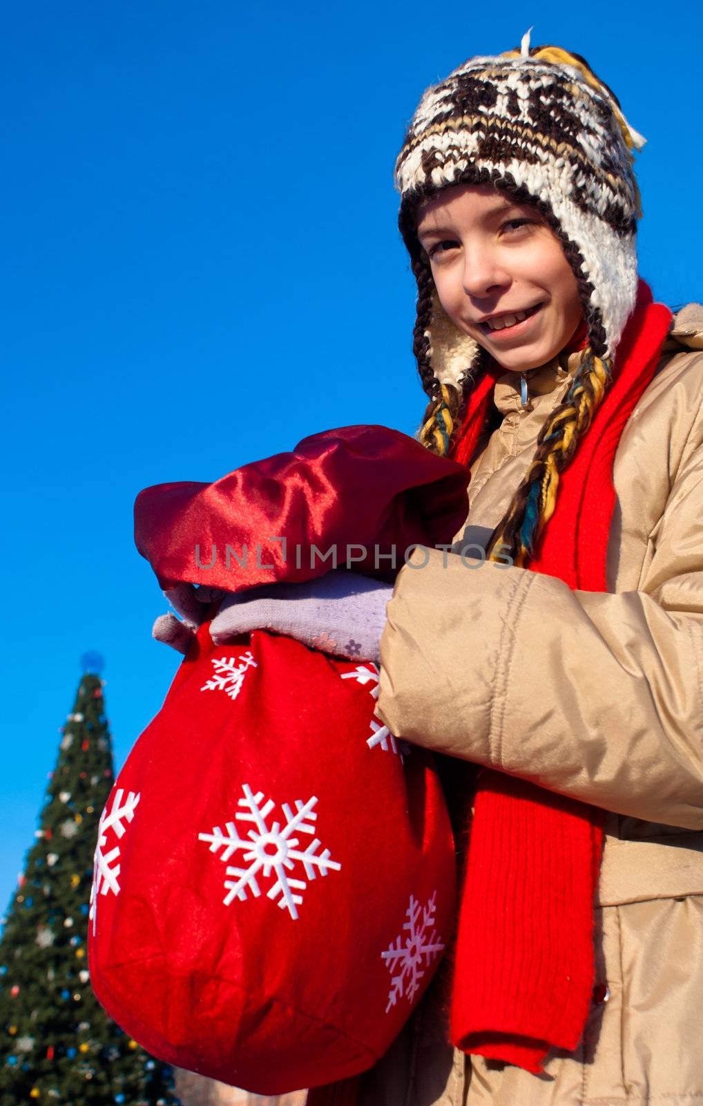 Girl holding a bag with Christmas presents