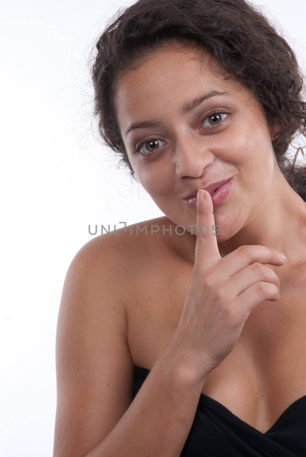 Beautiful young lady shushing in a studio pose.