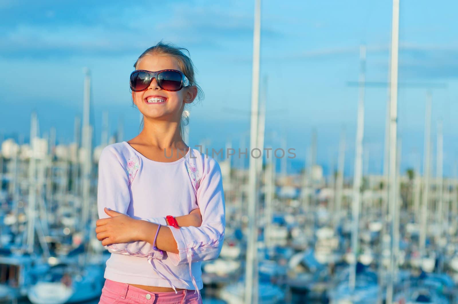 Closeup Portrait of a cute girl in the background of yachts