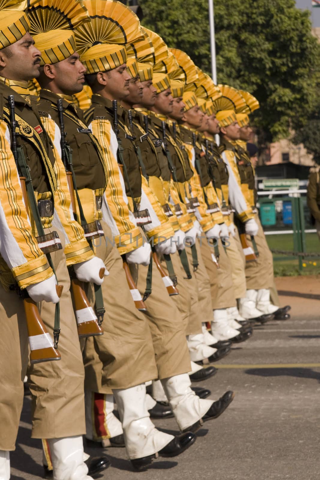 Soldiers in bright yellow trim parading down the Raj Path in preparation for the Republic Day Parade, New Delhi, India