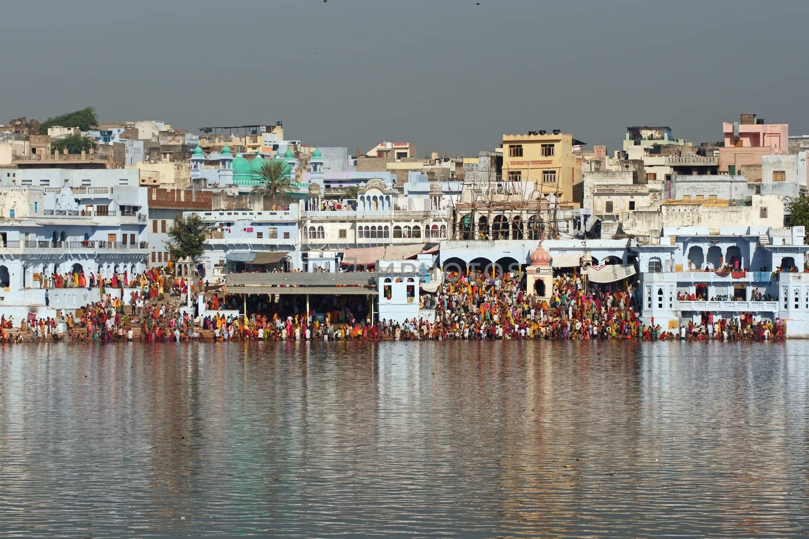 Crowds of people around a sacred lake during the Pushkar Fair, Rajasthan, India