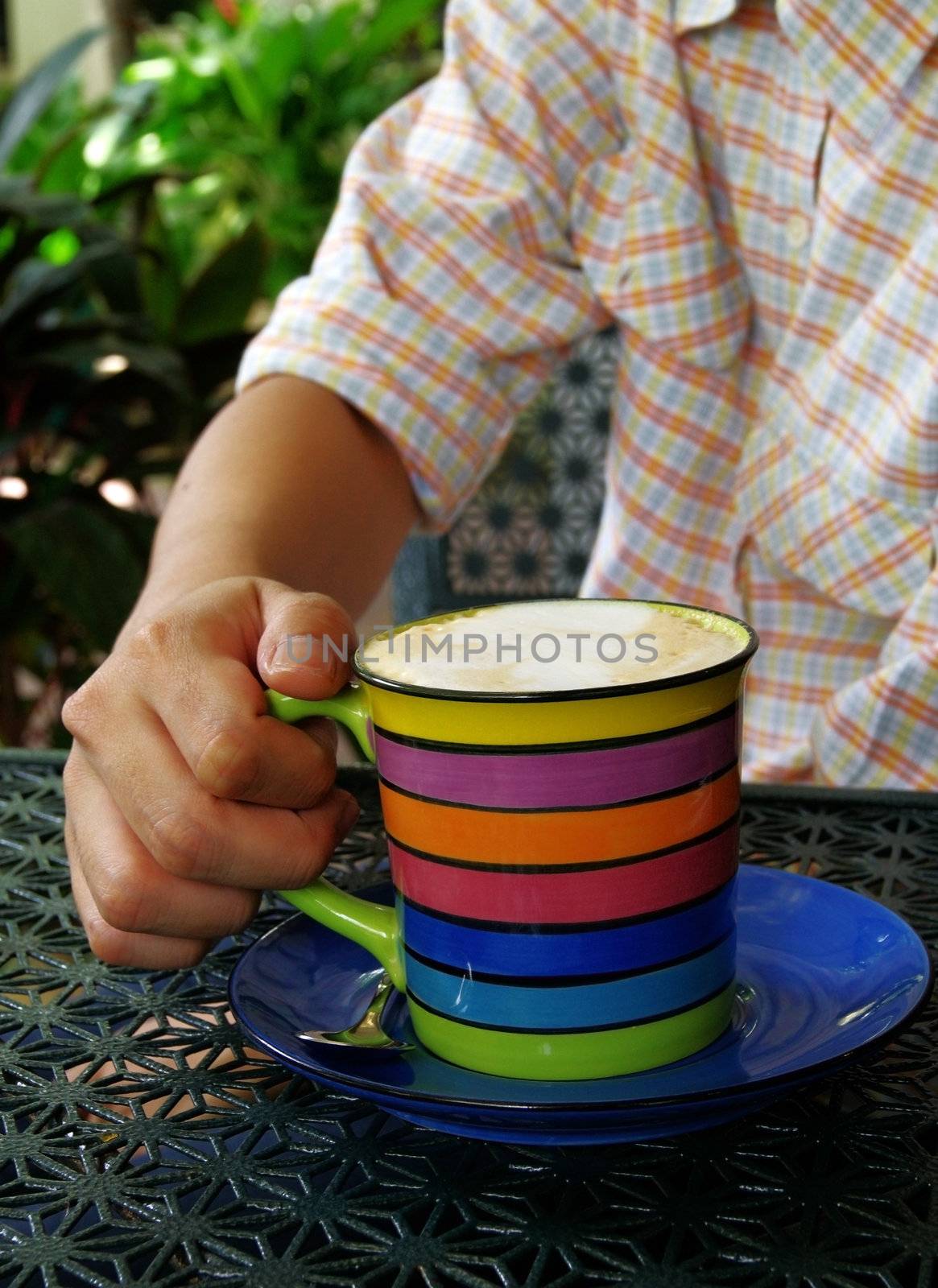 a cup of coffee in hand