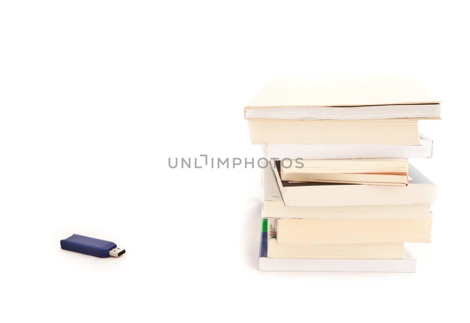 Concept of memories: blue usb key close to books