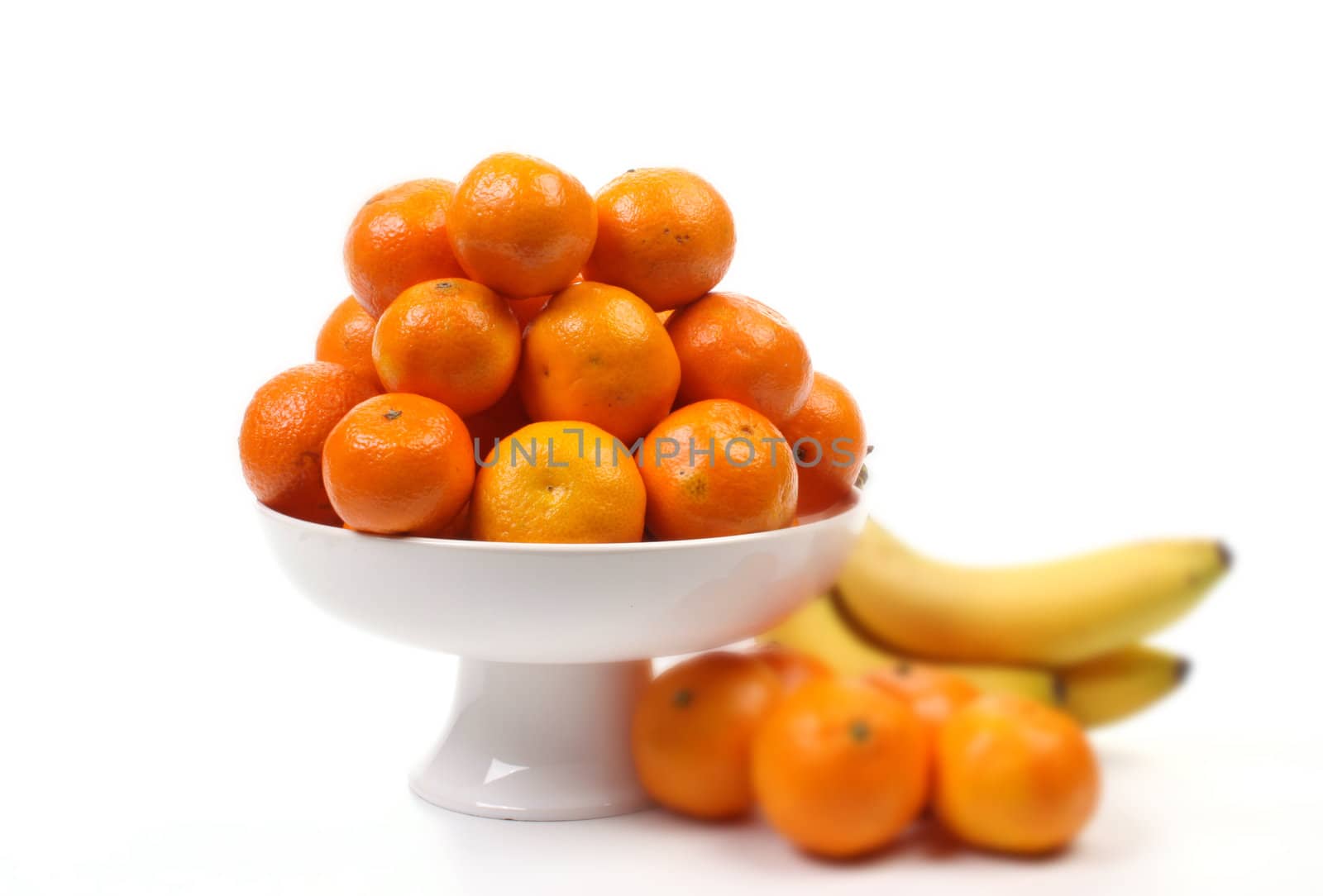 Mandarins and christmas balls over white