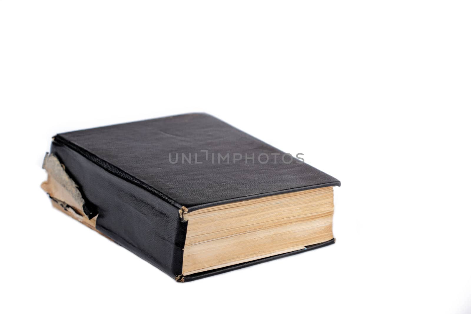 Old black covered closed book against white background