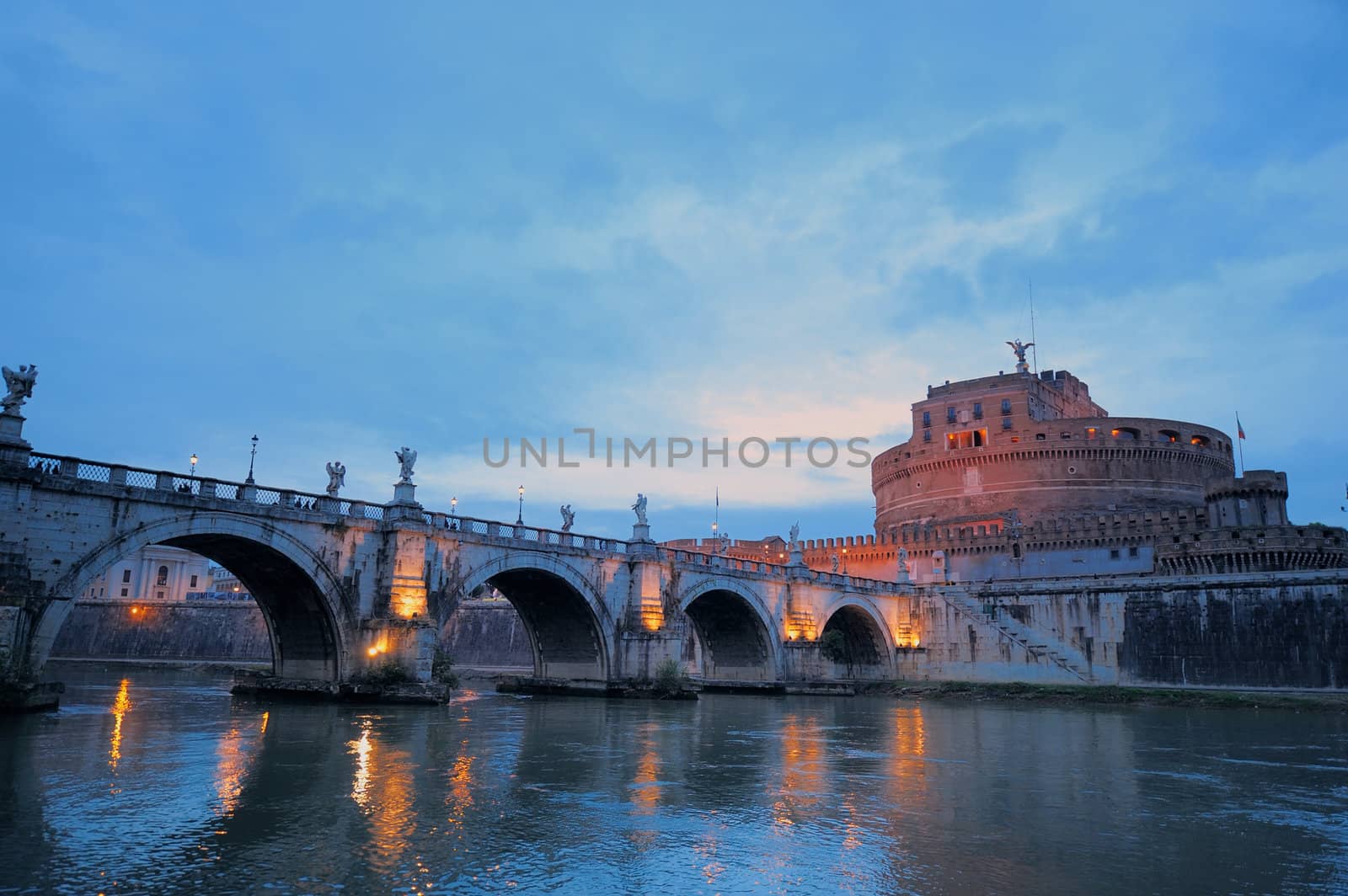Bridge crossing the river Tiber and Castle in twilight