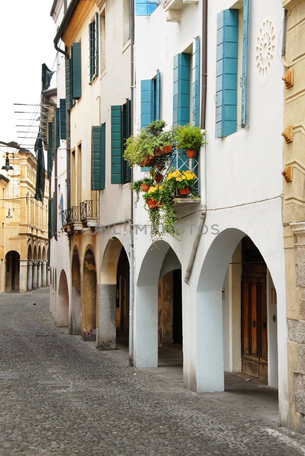 Street in Italy, terrace with flowerpots by simply