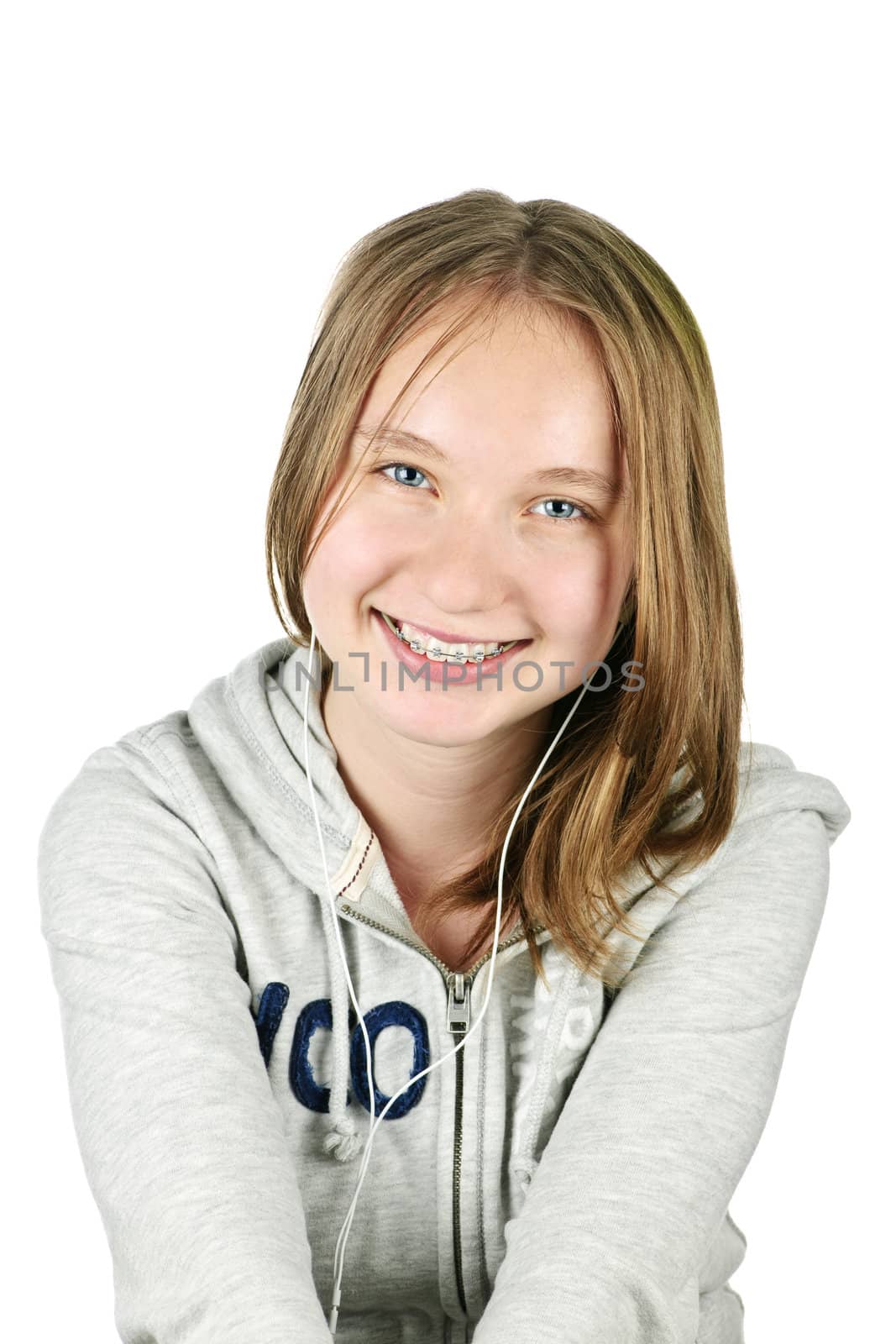 Isolated portrait of beautiful teenage girl listening to earphones