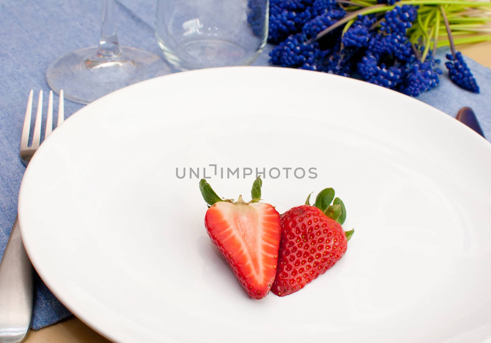 Halved Strawberry on Empty White Plate on Table