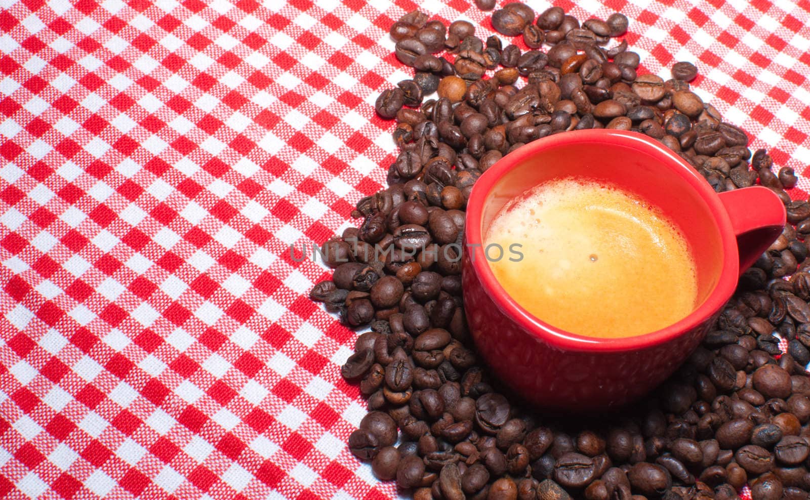 Cup of Coffee and Coffee Beans on Red Gingham cloth
