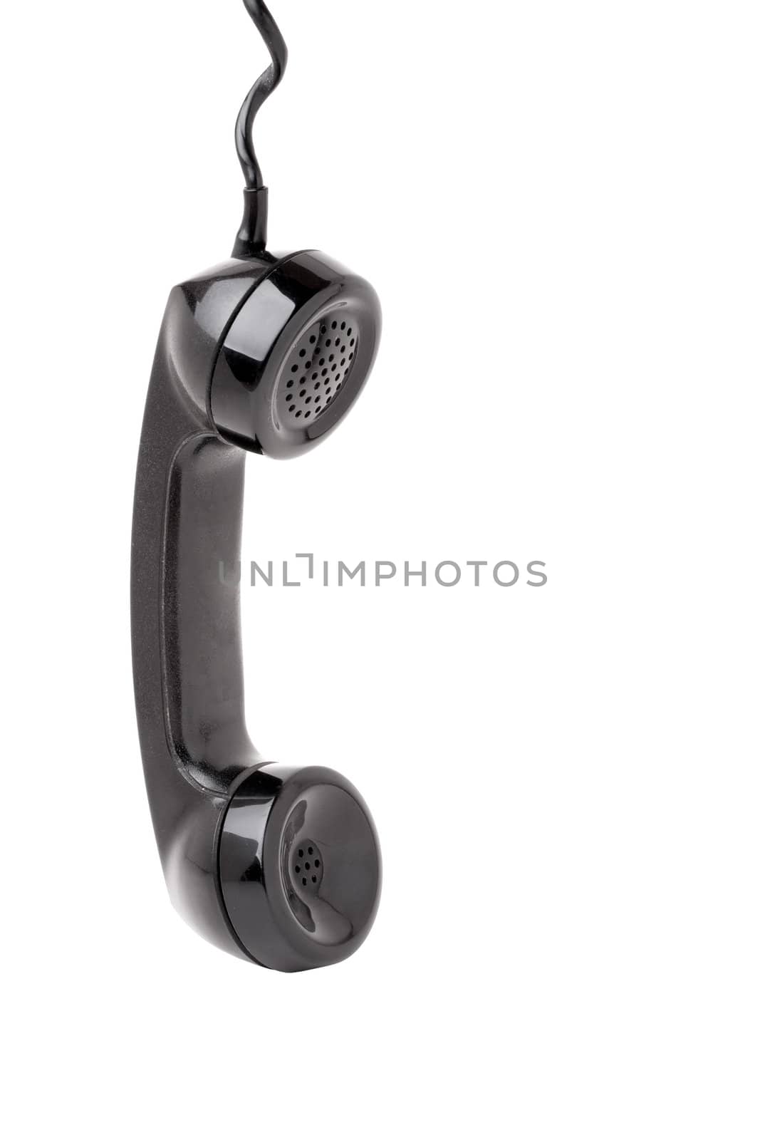 Close up of an old vintage phone handset hanging by the chord isolated over a white background.