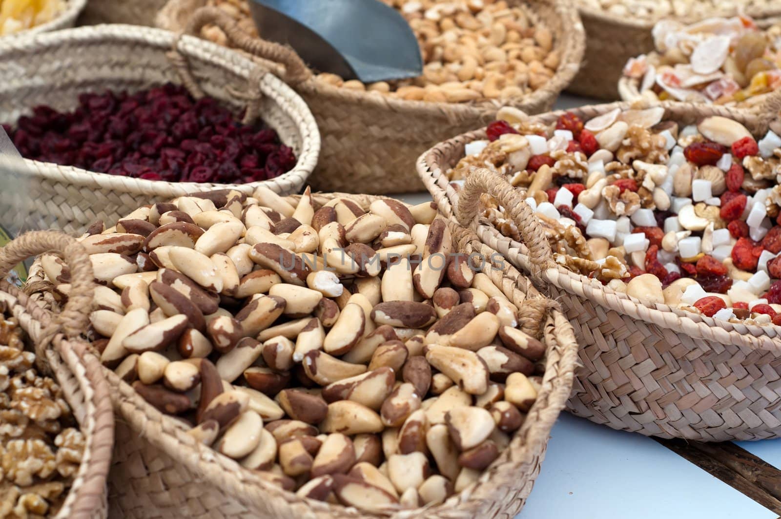 Different nuts in baskets on market, snack