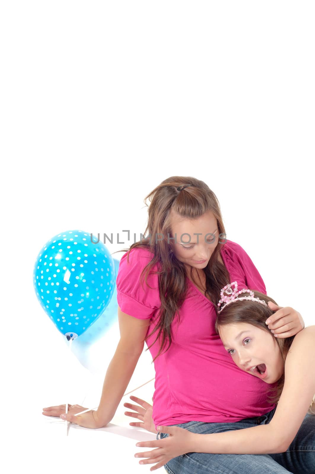 Beautiful pregnant woman with daughter in studio isolated on white