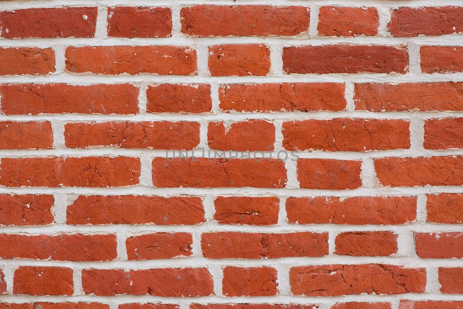 A pattern of red rectangular natural brick textured blocks.