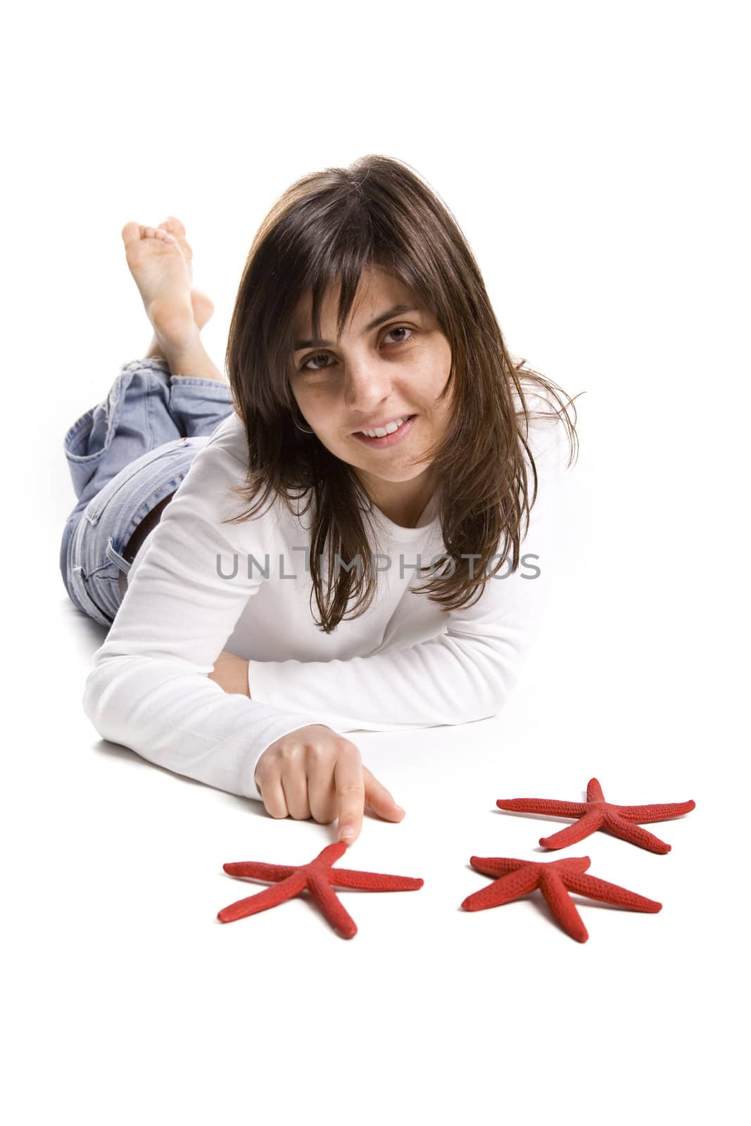 beautiful young woman playing with red starfish