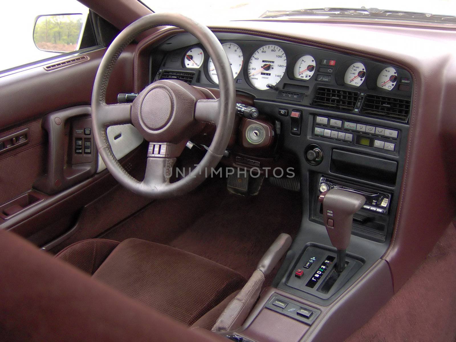 Sports car cockpit / interior.  Custom electro luminescent gauges in white carbon fiber.